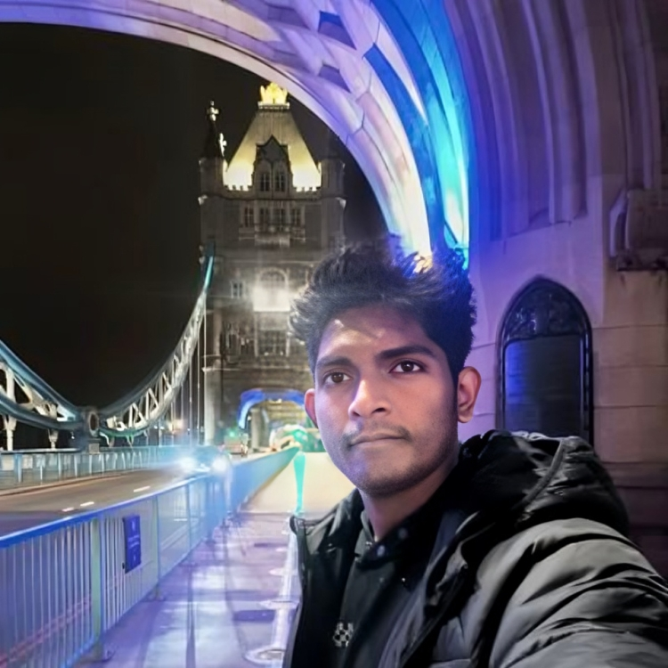 Anito Anto smiling while standing in front of London Bridge
